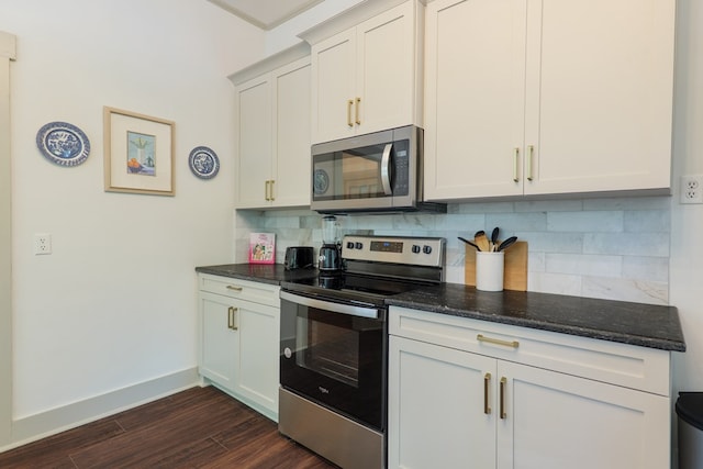 1611 N Patterson St, Valdosta, GA 31602 - kitchen featuring stainless steel appliances, backsplash, dark wood finished floors, dark stone counters, and crown molding