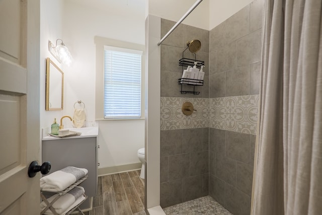 1611 N Patterson St, Valdosta, GA 31602 - full bath with vanity, wood finished floors, and tiled shower