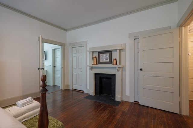 1611 N Patterson St, Valdosta, GA 31602 - living room featuring dark wood-style floors, a fireplace with flush hearth, and crown molding
