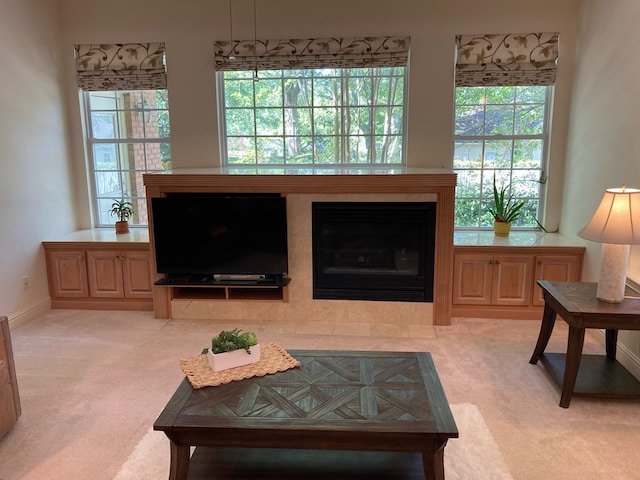 carpeted living room with a tiled fireplace