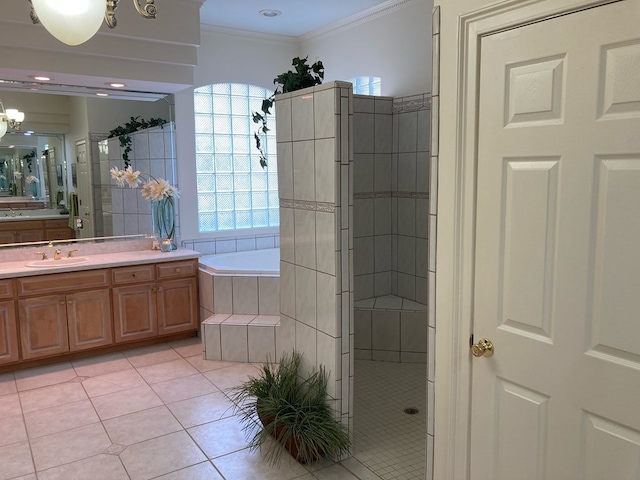 bathroom featuring tile patterned floors, ornamental molding, vanity, an inviting chandelier, and shower with separate bathtub