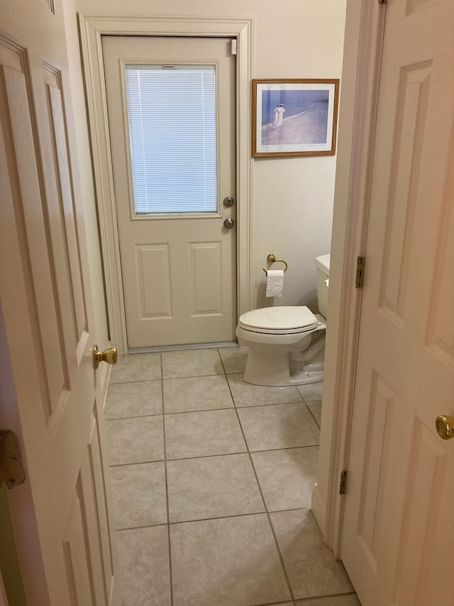 bathroom featuring tile patterned flooring and toilet