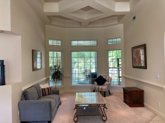 living room featuring beam ceiling, a towering ceiling, crown molding, and coffered ceiling