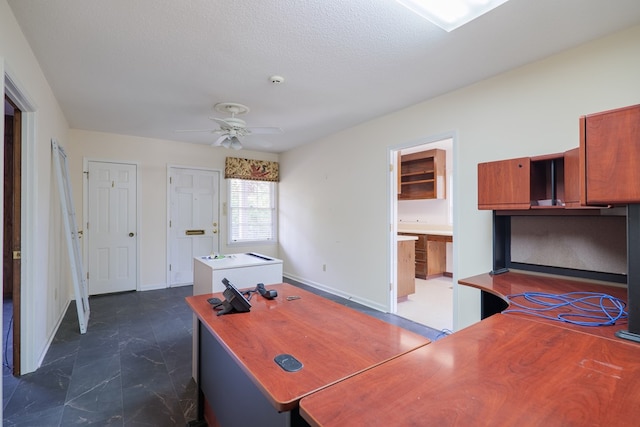 office area featuring ceiling fan and a textured ceiling