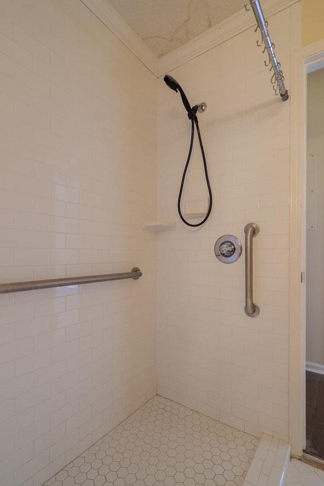 bathroom with tile patterned flooring and a tile shower