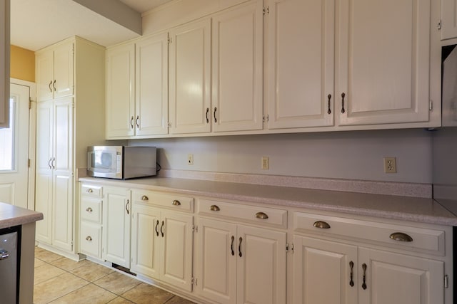 kitchen with white cabinets and light tile patterned floors