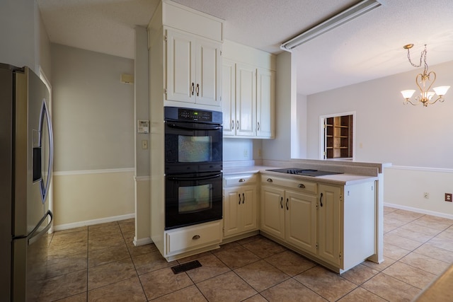 kitchen with hanging light fixtures, kitchen peninsula, a chandelier, a textured ceiling, and black appliances