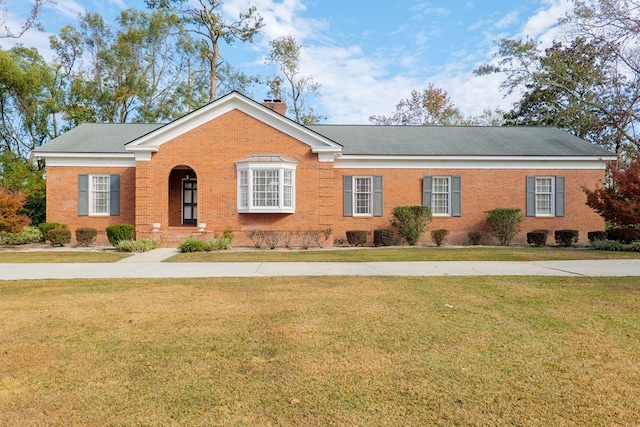 ranch-style home with a front lawn