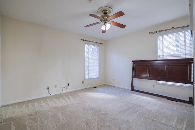 carpeted empty room with ceiling fan