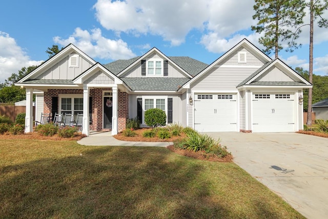 craftsman-style home featuring covered porch, a garage, and a front lawn