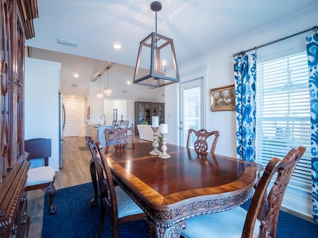 dining area with light wood-type flooring, visible vents, and recessed lighting