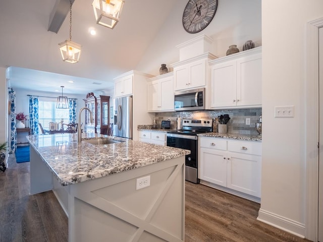 kitchen featuring a sink, white cabinetry, appliances with stainless steel finishes, dark wood-style floors, and tasteful backsplash