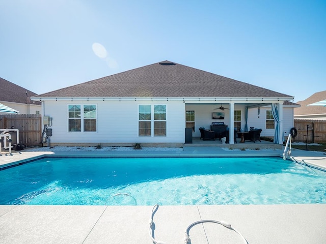 view of swimming pool with ceiling fan, a patio, fence, and a fenced in pool