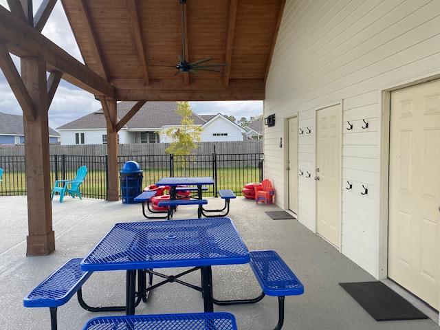 view of patio featuring ceiling fan and fence