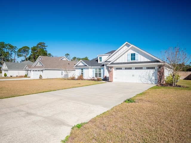 view of front of house featuring a garage, brick siding, concrete driveway, board and batten siding, and a front yard