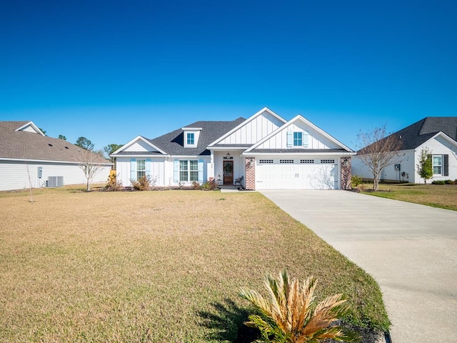 view of front of property featuring an attached garage, brick siding, concrete driveway, a front lawn, and board and batten siding