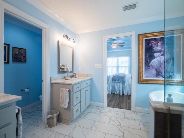 ensuite bathroom with marble finish floor, visible vents, vanity, ensuite bath, and baseboards