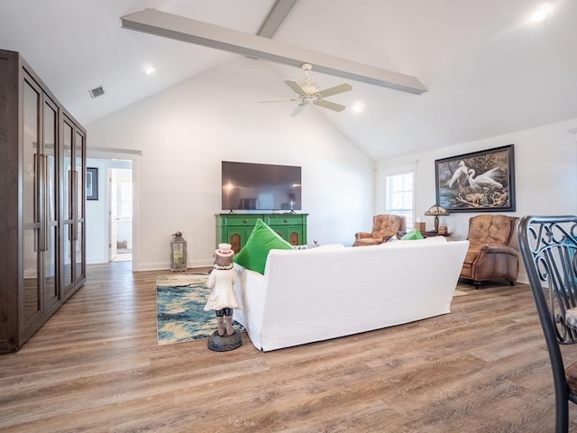 living area featuring visible vents, a ceiling fan, light wood-style flooring, beamed ceiling, and high vaulted ceiling