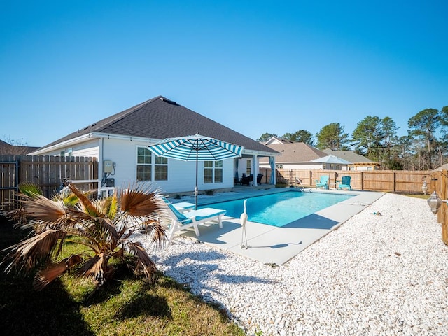 view of swimming pool featuring a fenced in pool, a patio area, and a fenced backyard