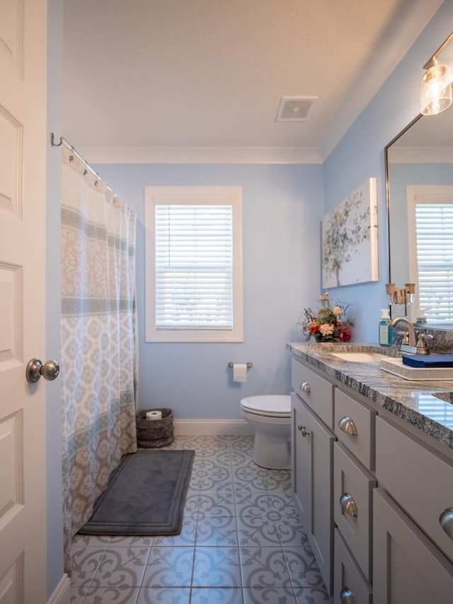 bathroom with visible vents, toilet, vanity, baseboards, and tile patterned floors