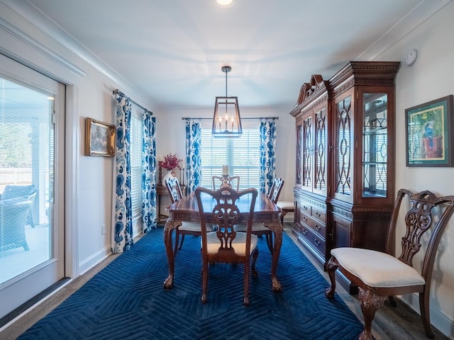 dining room with a chandelier and baseboards