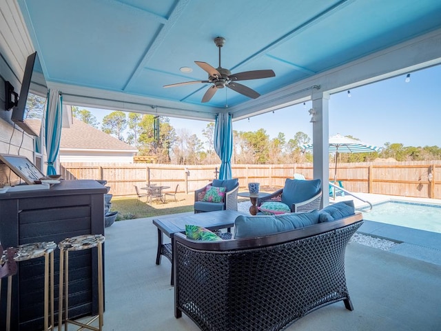 view of patio with ceiling fan, a fenced backyard, and an outdoor living space