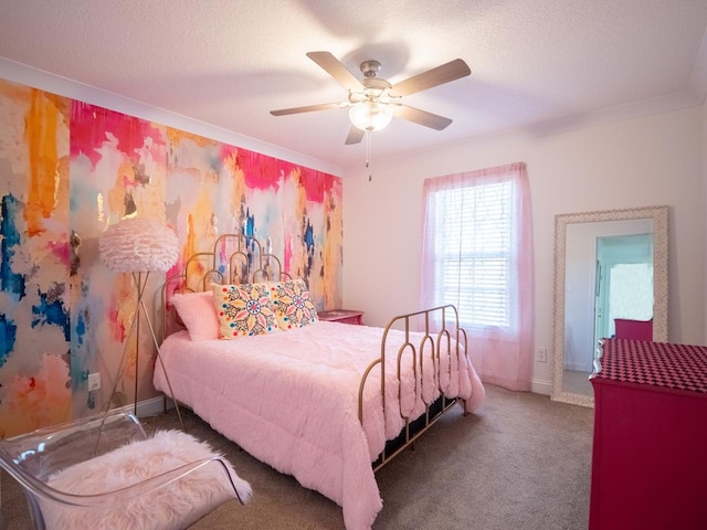 carpeted bedroom with a textured ceiling, ornamental molding, a ceiling fan, and baseboards