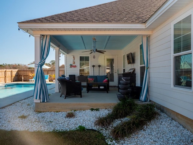 view of patio featuring a fenced in pool, fence, outdoor lounge area, and a ceiling fan