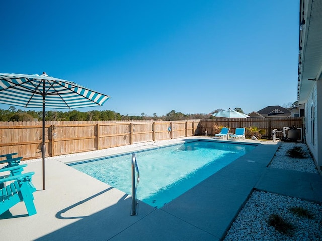 view of swimming pool featuring a patio, a fenced backyard, and a fenced in pool