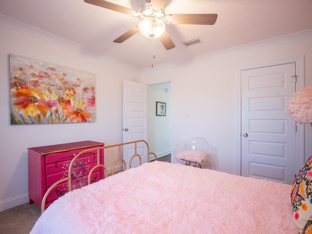 bedroom featuring ornamental molding, carpet, visible vents, and a ceiling fan