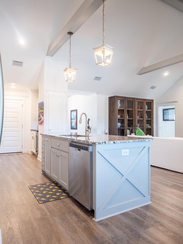 kitchen featuring lofted ceiling with beams, stainless steel dishwasher, light wood-style flooring, and visible vents