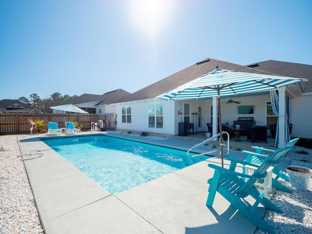 view of pool featuring a fenced in pool, a patio area, ceiling fan, and a fenced backyard