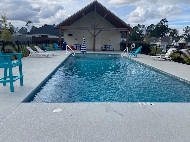 pool featuring a patio area and fence