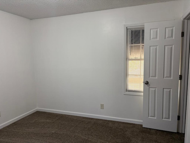 carpeted spare room featuring a textured ceiling