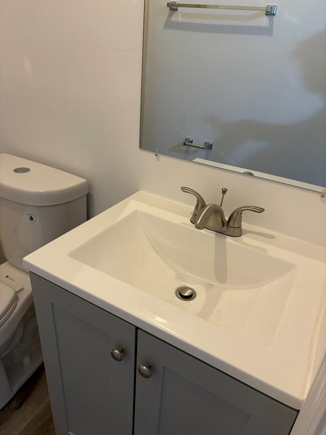 bathroom featuring toilet and vanity