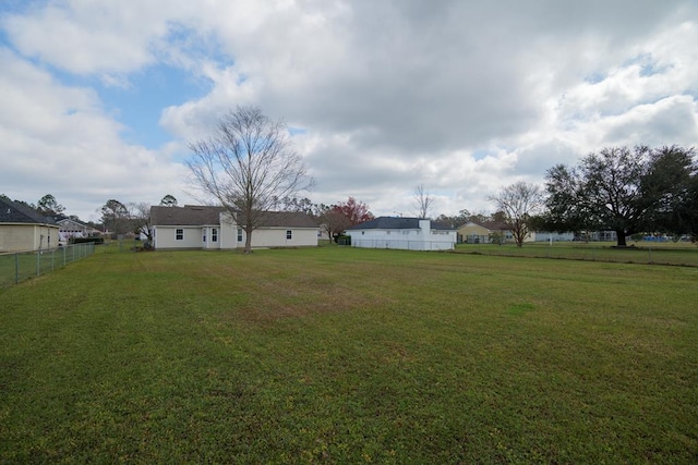 view of yard featuring a residential view and fence