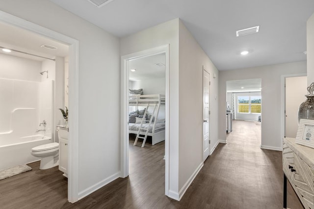 full bathroom featuring vanity, hardwood / wood-style flooring, toilet, and shower / washtub combination