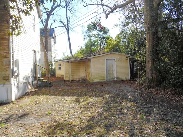 view of outbuilding featuring entry steps and an outbuilding