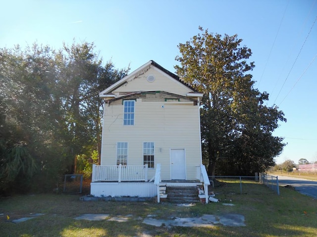 view of front of property with a deck and fence