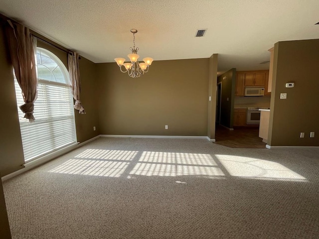 4331 Summerlin Dr, Valdosta, GA 31605 - spare room featuring baseboards, visible vents, carpet flooring, and a notable chandelier