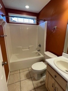 bathroom featuring toilet, shower / bathing tub combination, tile patterned flooring, and vanity