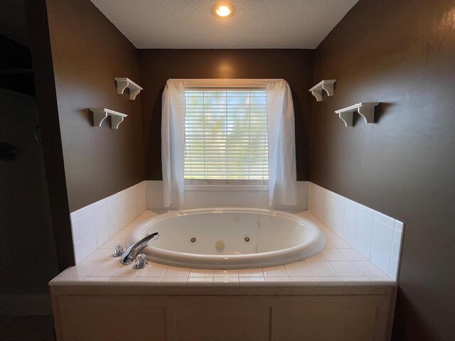 4331 Summerlin Dr, Valdosta, GA 31605 - bathroom featuring a tub with jets and a textured ceiling
