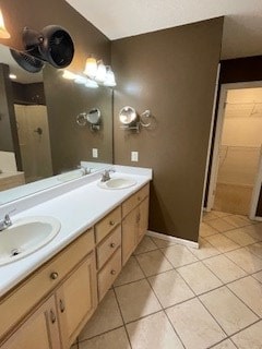 full bathroom with a sink, tile patterned flooring, and double vanity