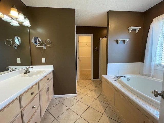4331 Summerlin Dr, Valdosta, GA 31605 - full bath featuring a walk in closet, a bath, vanity, baseboards, and tile patterned floors