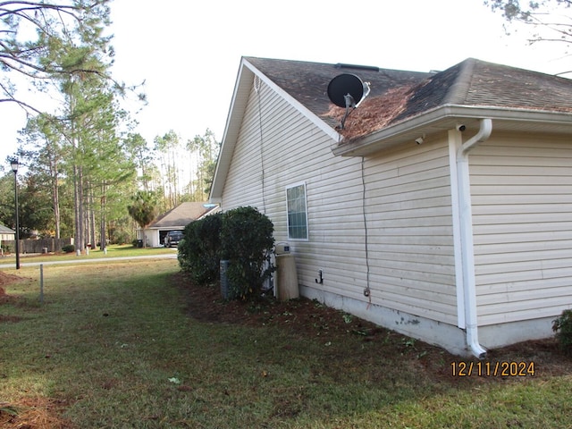 view of side of home with a lawn