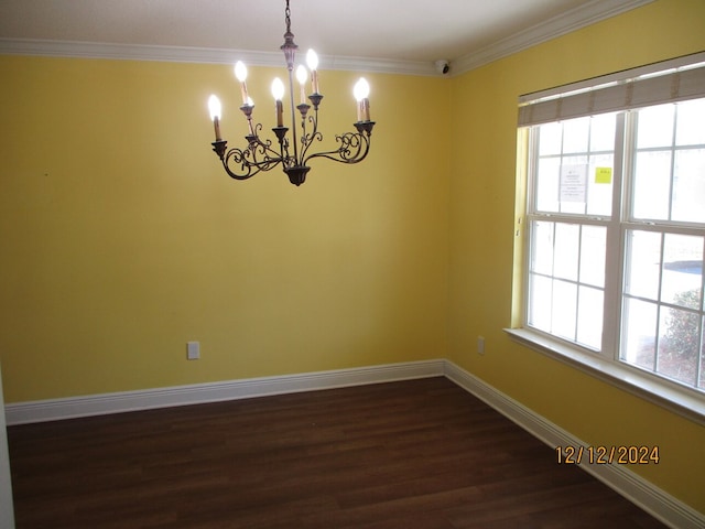 unfurnished room with ornamental molding, dark hardwood / wood-style floors, a wealth of natural light, and a notable chandelier