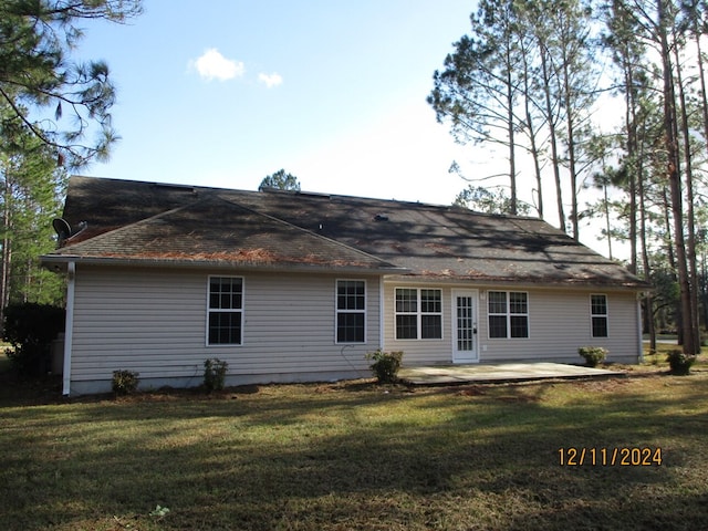 back of property featuring a lawn and a patio