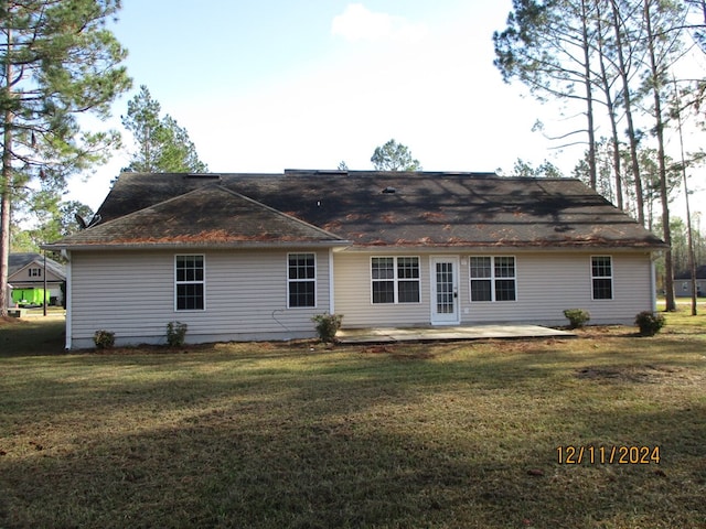 back of property with a patio and a lawn