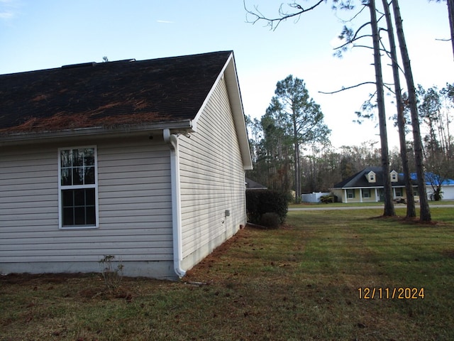 view of side of home featuring a yard