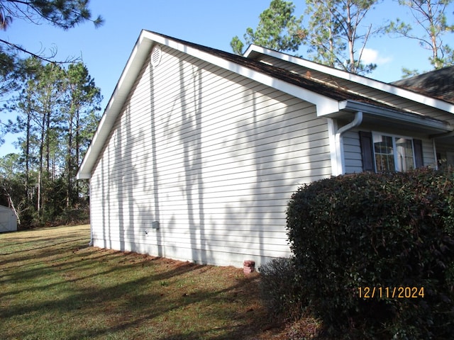 view of home's exterior with a lawn